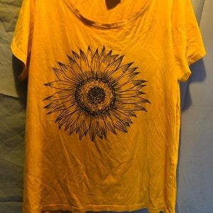I’m selling a yellow t- shirt with a jumbo faded sunflower design in the back